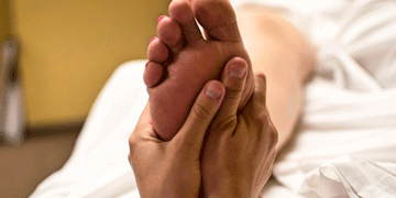 Someone receiving reflexology