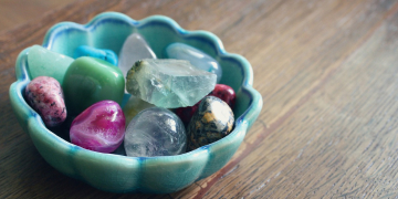 crystal therapy. A pot of various crystals on a wooden table